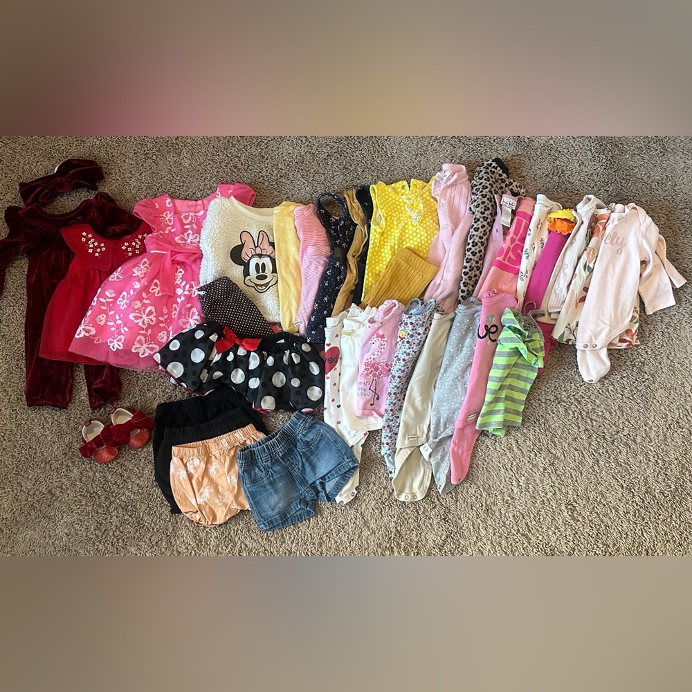 Bundle of baby girl clothes. Sizes range from newborn-9 months.